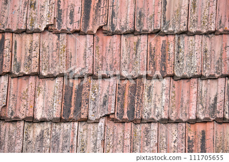 Closeup surface of old weathered ceramic tiles covering building roof Closeup surface of old weathered ceramic tiles covering building roof 111705655