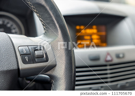 Closeup detail view of a steering wheel of a car. 111705670