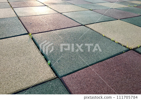Close up of soft rubber tiles for covering at outdoor gym of stadium at preschool yard. 111705784