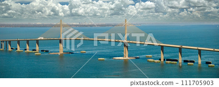 Aerial view of Sunshine Skyway Bridge over Tampa Bay in Florida with moving traffic. Concept of transportation infrastructure Aerial view of Sunshine Skyway Bridge over Tampa Bay in Florida with moving traffic. Concept of transportation infrastructure 111705903