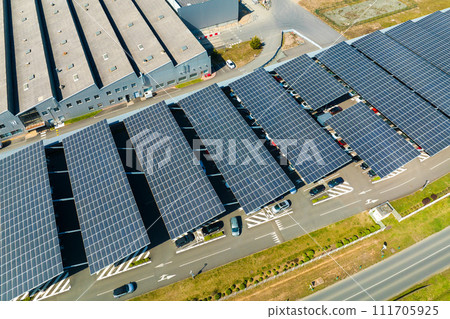 Aerial view of solar panels installed over parking lot with parked cars for effective generation of clean energy 111705925