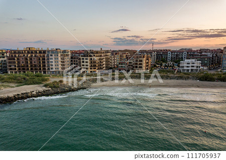Aerial view of Pomorie city that is located on Black Sea shore. Top view of sand beaches with many hotel buildings and tourist infrastructure. Aerial view of Pomorie city that is located on Black Sea shore. Top view of sand beaches with many hotel buildings and tourist infrastructure. 111705937