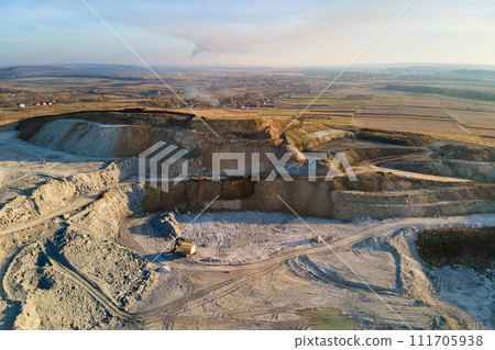 Aerial view of open pit mine of sandstone materials for construction industry with excavators and dump trucks. Heavy equipment in mining and production of useful minerals concept Aerial view of open pit mine of sandstone materials for construction industry with excavators and dump trucks. Heavy equipment in mining and production of useful minerals concept 111705938