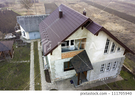 Aerial view of new residential house cottage with shingle roof. 111705940