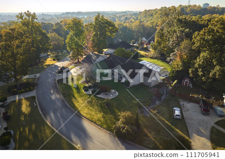 Aerial view of new family house between yellow trees in South Carolina suburban area in fall season. Real estate development in american suburbs 111705941