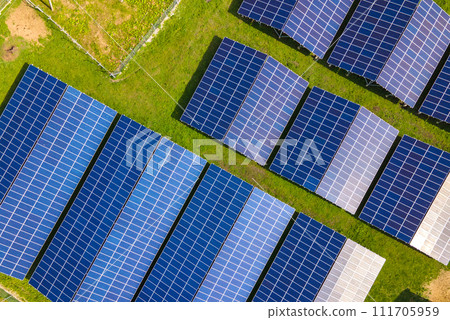 Aerial view of large sustainable electrical power plant with rows of solar photovoltaic panels for producing clean ecological electric energy. Renewable electricity with zero emission concept. 111705959