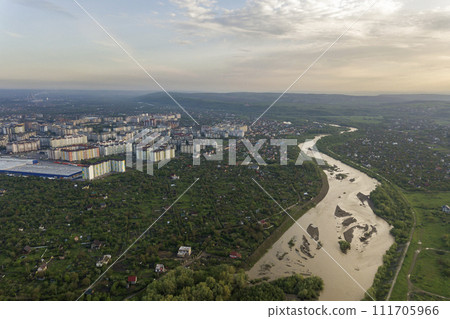 Aerial view of Ivano-Frankivsk city with residential area and suburb houses with a river in middle. 111705966