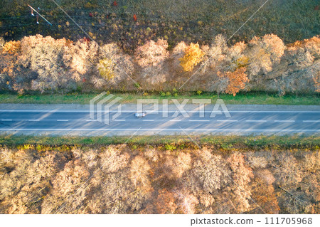 Aerial view of intercity road with blurred fast driving environment friendly electric car at sunset. Top view from drone of highway traffic in evening Aerial view of intercity road with blurred fast driving environment friendly electric car at sunset. Top view from drone of highway traffic in evening 111705968