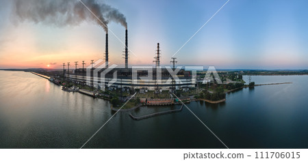 Aerial view of coal power plant high pipes with black smokestack polluting atmosphere. Electricity production with fossil fuel concept Aerial view of coal power plant high pipes with black smokestack polluting atmosphere. Electricity production with fossil fuel concept 111706015