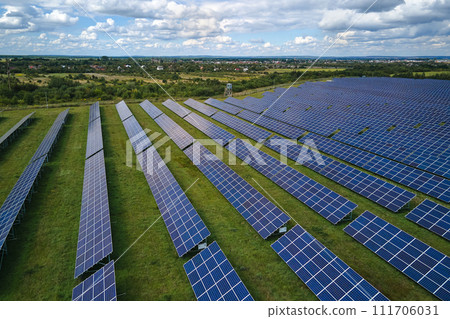 Aerial view of big sustainable electric power plant with many rows of solar photovoltaic panels for producing clean electrical energy. Renewable electricity with zero emission concept 111706031