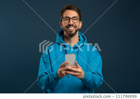Portrait Of Smiling Handsome Young Man With Smartphone In Hands 111706099