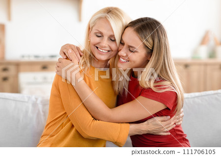 Loving adult woman hugging her senior mother 111706105