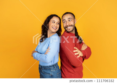 Positive millennial man and woman standing back to back 111706182