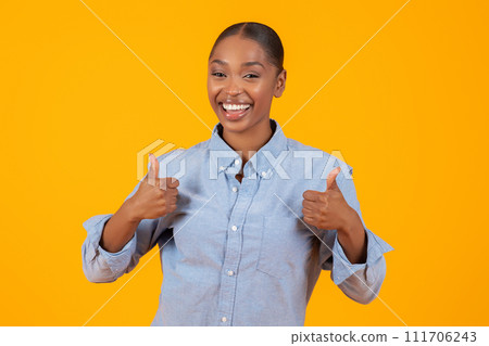 black woman showing Thumbs Up gesture with both hands, studio black woman showing Thumbs Up gesture with both hands, studio 111706243