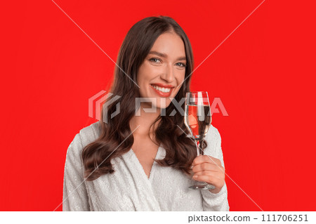 Portrait of young woman offering champagne toast on red background Portrait of young woman offering champagne toast on red background 111706251
