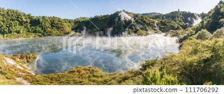 Panoramic view on huge boiling geothermal lake surrounded by lush green foliage, New Zealand Panoramic view on huge boiling geothermal lake surrounded by lush green foliage, New Zealand 111706292