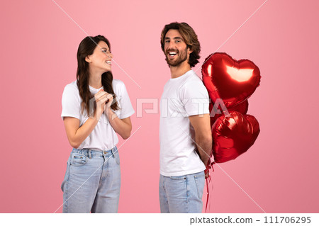 Laughing woman and man in white t-shirts looking at each other with joy 111706295