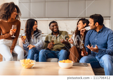 Diverse millennials friends come together for joyous party indoors 111706412