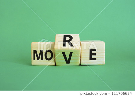 More Move symbol. Wooden cubes with words More Move. Beautiful green background. Business concept and More Move. Copy space 111706654