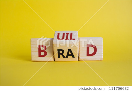 Build your brand symbol. Wooden cubes with words Build and Brand. Beautiful yellow background. Build your brand and business concept. Copy space Build your brand symbol. Wooden cubes with words Build and Brand. Beautiful yellow background. Build your brand and business concept. Copy space 111706682