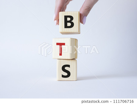 BTS symbol. Wooden cubes with word BTS. Businessman hand Beautiful white background. BTS concept. Copy space. BTS symbol. Wooden cubes with word BTS. Businessman hand Beautiful white background. BTS concept. Copy space. 111706716