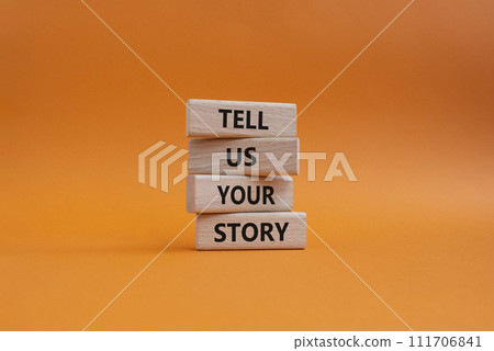 Tell us your story symbol. Concept words Tell us your story on wooden blocks. Beautiful orange background. Business and Tell us your story concept. Copy space. Tell us your story symbol. Concept words Tell us your story on wooden blocks. Beautiful orange background. Business and Tell us your story concept. Copy space. 111706841
