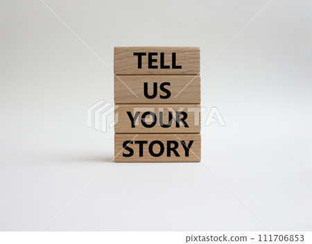 Tell us your story symbol. Concept words Tell us your story on wooden blocks. Beautiful white background. Business and Tell us your story concept. Copy space. 111706853