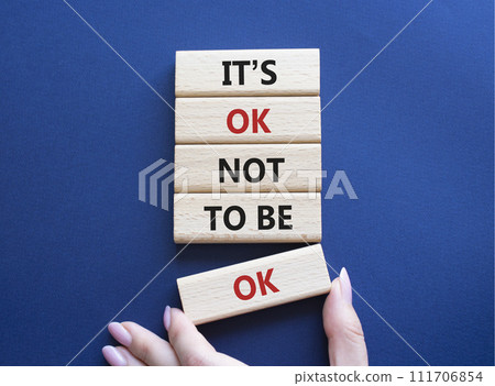 Mental Health symbol. Wooden blocks with words It is ok not to be ok. Doctor hand. Beautiful deep blue background. Mental Health concept. Copy space. 111706854
