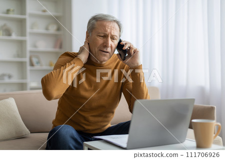 Stressed elderly businessman have phone conversation, working from home Stressed elderly businessman have phone conversation, working from home 111706926