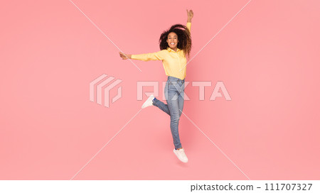 Elegant black lady posing against pink backdrop Elegant black lady posing against pink backdrop 111707327