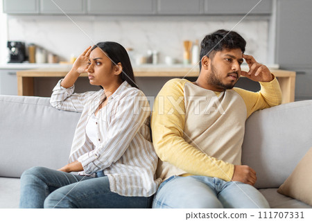 Young Offended Indian Couple Sitting Back To Back On Couch At Home 111707331