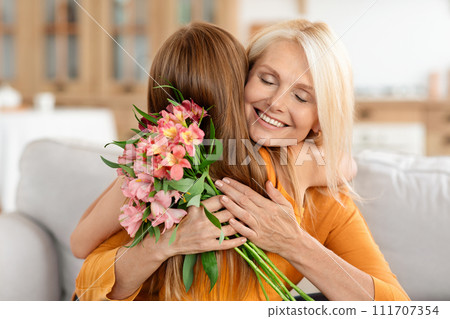 Granddaughter greeting beautiful granny with International Womens Day 111707354