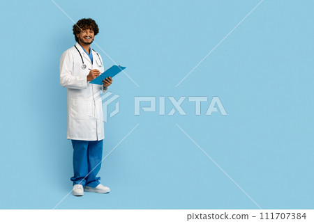 Happy young indian man in medical workwear doctor, copy space 111707384