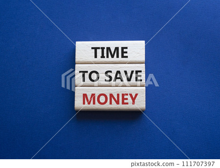 Time to save money symbol. Wooden blocks with words Time to save money. Beautiful deep blue background. Business and Time to save money concept. Copy space. 111707397