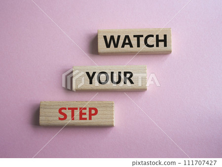 Watch your Step symbol. Concept words Watch your Step on wooden blocks. Beautiful pink background. Business and Watch your Step concept. Copy space. Watch your Step symbol. Concept words Watch your Step on wooden blocks. Beautiful pink background. Business and Watch your Step concept. Copy space. 111707427