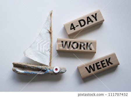 4-day work week symbol. Concept words 4-day work week on wooden blocks. Beautiful white background with boat. Business and 4-day work week concept. Copy space 4-day work week symbol. Concept words 4-day work week on wooden blocks. Beautiful white background with boat. Business and 4-day work week concept. Copy space 111707432