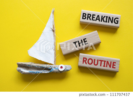 Breaking the Routine week symbol. Concept words Breaking the Routine on wooden blocks. Beautiful yellow background with boat. Business and Breaking the Routine concept. Copy space Breaking the Routine week symbol. Concept words Breaking the Routine on wooden blocks. Beautiful yellow background with boat. Business and Breaking the Routine concept. Copy space 111707437