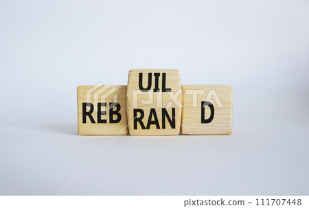 Rebuild and Rebrand symbol. Wooden cubes with words Rebrand and Rebuild. Beautiful white background. Rebuild Rebrand and Business concept. Copy space 111707448