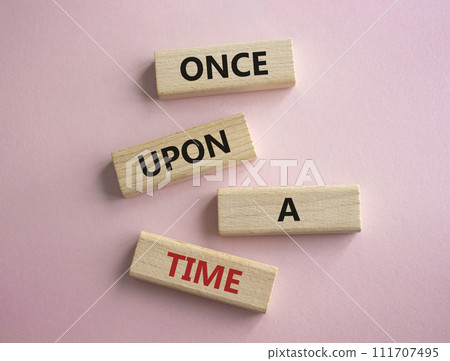 Once upon a time symbol. Concept words. Once upon a time on wooden blocks. Beautiful pink background. Business and Once upon a time concept. Copy space Once upon a time symbol. Concept words. Once upon a time on wooden blocks. Beautiful pink background. Business and Once upon a time concept. Copy space 111707495