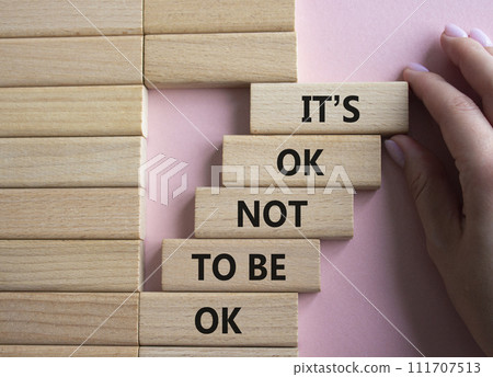 Mental Health symbol. Wooden blocks with words It is ok not to be ok. Doctor hand. Beautiful pink background. Mental Health concept. Copy space. 111707513