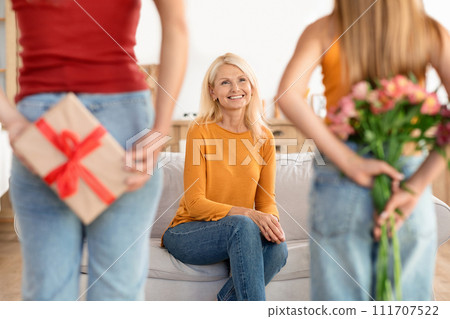 Daughter and granddaughter with a secret gift 111707522