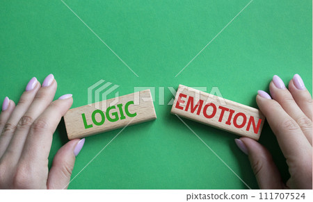 Logic or Emotion symbol. Concept word Logic or Emotion on wooden blocks. Businessman hand. Beautiful green background. Business and Logic or Emotion concept. Copy space Logic or Emotion symbol. Concept word Logic or Emotion on wooden blocks. Businessman hand. Beautiful green background. Business and Logic or Emotion concept. Copy space 111707524