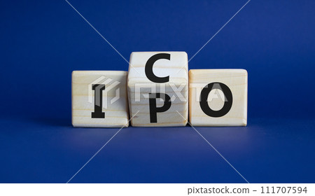 ICO and IPO symbol. Wooden cubes with words ICO - initial coin offering and IPO - initial public offering. Beautiful deep blue background. Business concept. Copy space ICO and IPO symbol. Wooden cubes with words ICO - initial coin offering and IPO - initial public offering. Beautiful deep blue background. Business concept. Copy space 111707594