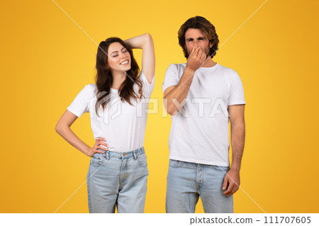 Relaxed woman smiling with hand behind head and a man pinching his nose 111707605