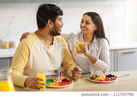 Married couple enjoying time together, cuddling, talking, eating lunch 111707706