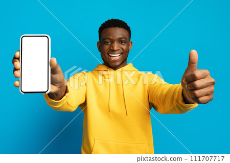 Positive african american guy showing phone and thumb up 111707717