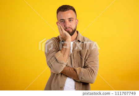 Tired boring sick young european man presses hands to face, rest 111707749