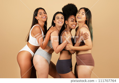 Four joyful women in underwear, celebrating diversity and beauty 111707764