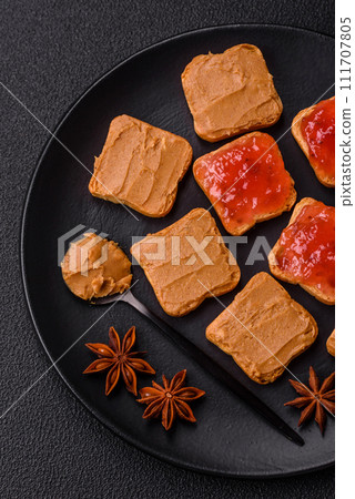 Delicious nutritious sandwiches with peanut butter, strawberry jam 111707805