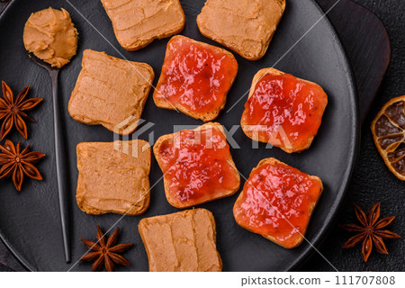 Delicious nutritious sandwiches with peanut butter, strawberry jam Delicious nutritious sandwiches with peanut butter, strawberry jam 111707808